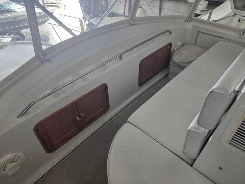 Slide: The Image of 1989 Chris-Craft 42 Sportfish Commander interior with seating and storage compartments. - 25