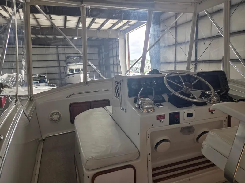 Slide: The Image of 1989 Chris-Craft 42 Sportfish Commander helm in a boat storage facility. - 26