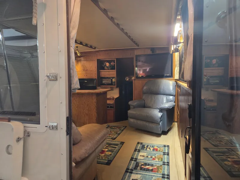 Slide: The Image of Interior of 1989 Chris-Craft 42 Sportfish Commander with cozy seating and wood paneling. - 34