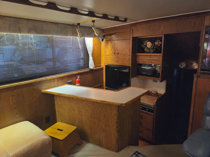 Slide: The Image of Interior of 1989 Chris-Craft 42 Sportfish Commander with wood cabinetry and seating area. - 38