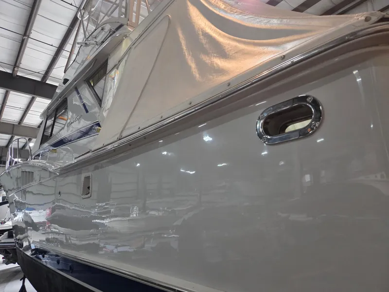 Slide: The Image of 1989 Chris-Craft 42 Sportfish Commander in a warehouse, showcasing sleek exterior design. - 4