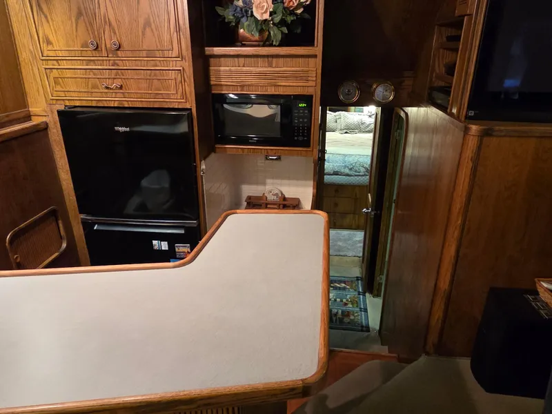 Slide: The Image of 1989 Chris-Craft 42 Commander Sportfish interior with kitchen and cozy cabin view. - 41