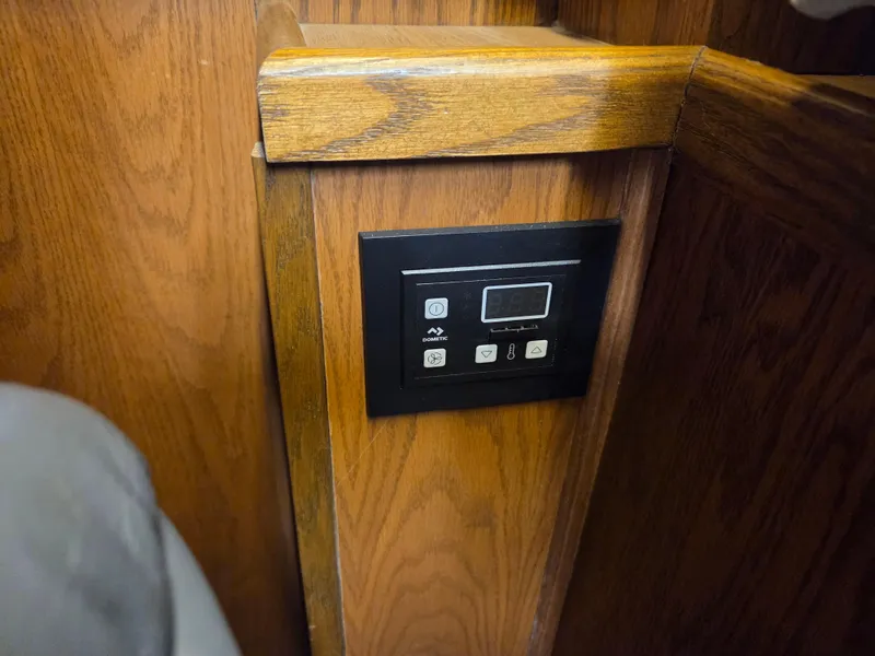 Slide: The Image of Control panel on 1989 Chris-Craft 42 Sportfish Commander, mounted on wooden interior. - 49