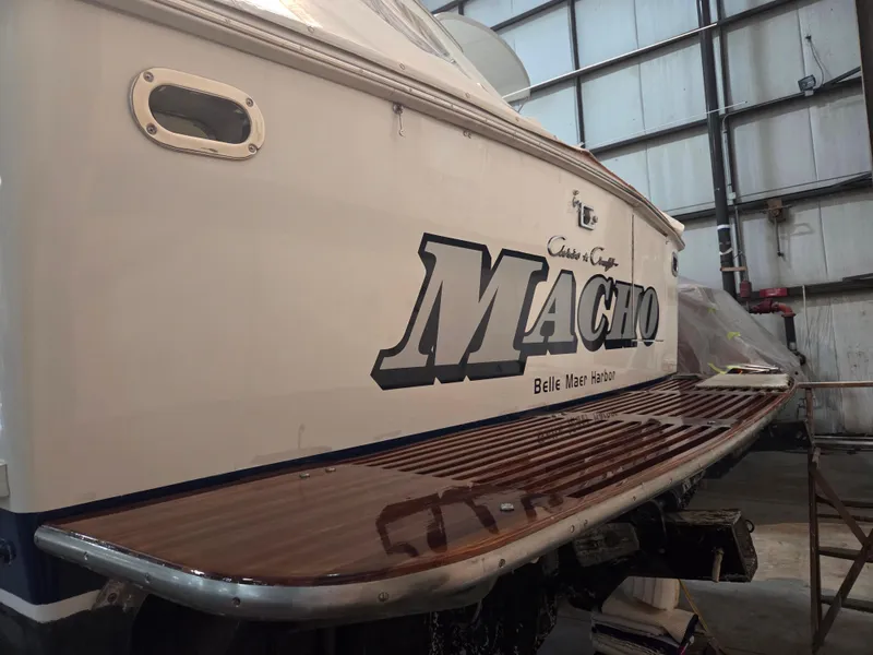 Slide: The Image of 1989 Chris-Craft 42 Sportfish Commander boat in a garage, featuring "Macho" name on the stern. - 7