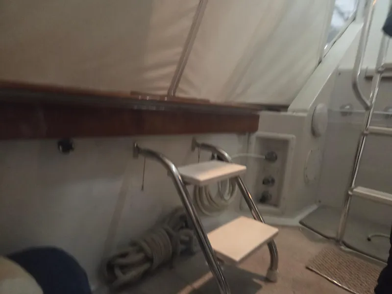 Slide: The Image of Interior of 1989 Chris-Craft 42 Sportfish Commander with ladder and coiled rope. - 75