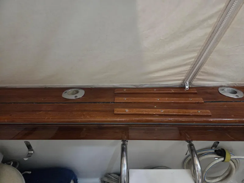 Slide: The Image of 1989 Chris-Craft 42 Sportfish Commander, wooden deck detail with metal fixtures. - 76