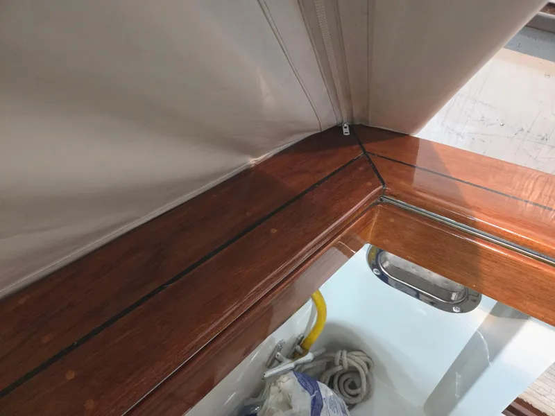 Slide: The Image of 1989 Chris-Craft 42 Sportfish Commander interior with polished wood and white upholstery. - 77