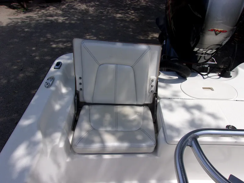 Slide: The Image of White seat on 2018 Blue Wave 2000 SL boat with motor in background. - 12