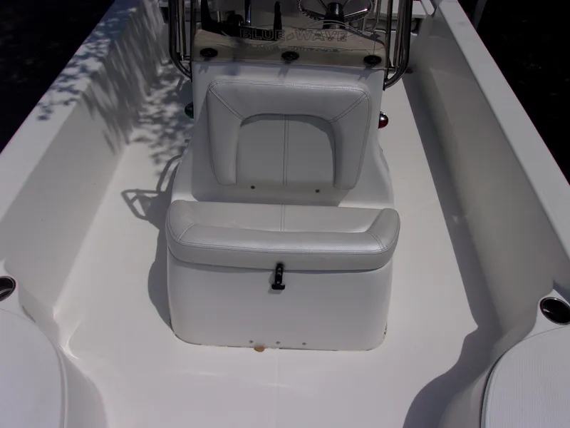 Slide: The Image of 2018 Blue Wave 2000 SL boat interior with white seating and console. - 15