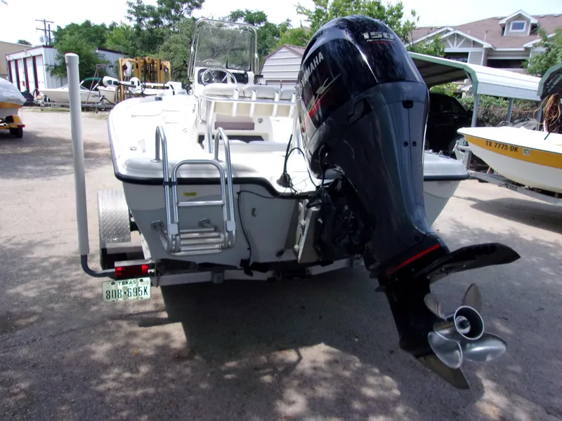 Slide: The Image of 2018 Blue Wave 2000 SL boat with Yamaha outboard motor, parked on a trailer. - 4