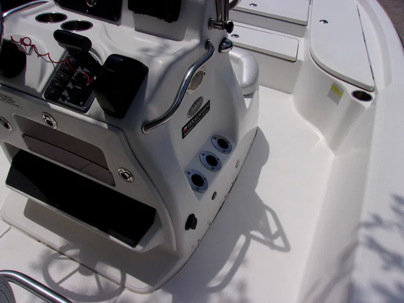 Slide: The Image of Center console of a 2018 Blue Wave 2000 SL boat, featuring control panel and seating. - 8