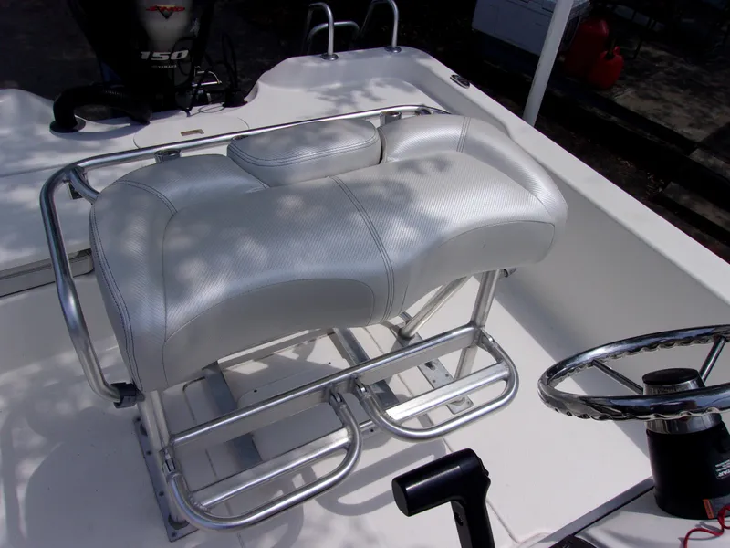 Slide: The Image of White cushioned seating on 2018 Blue Wave 2000 SL boat with steering wheel and motor. - 9