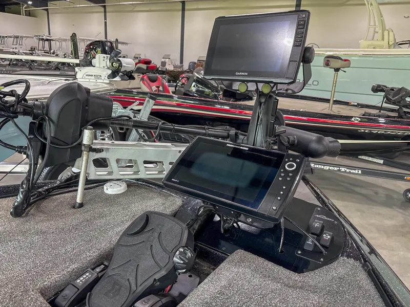 Slide: The Image of Fishing boat cockpit with dual Garmin screens, Falcon F21 model, 2020, in a showroom setting. - 10