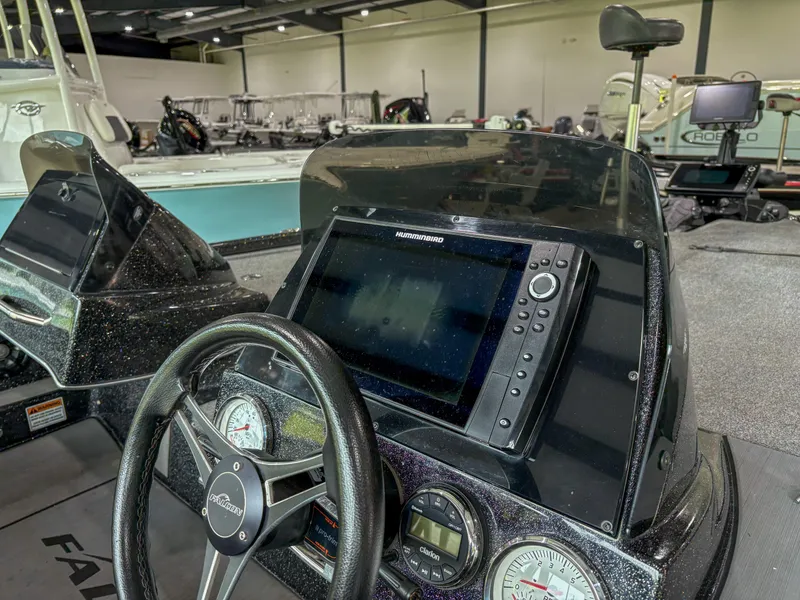 Slide: The Image of Steering console of a 2020 Falcon F21 boat with navigation system and gauges. - 6