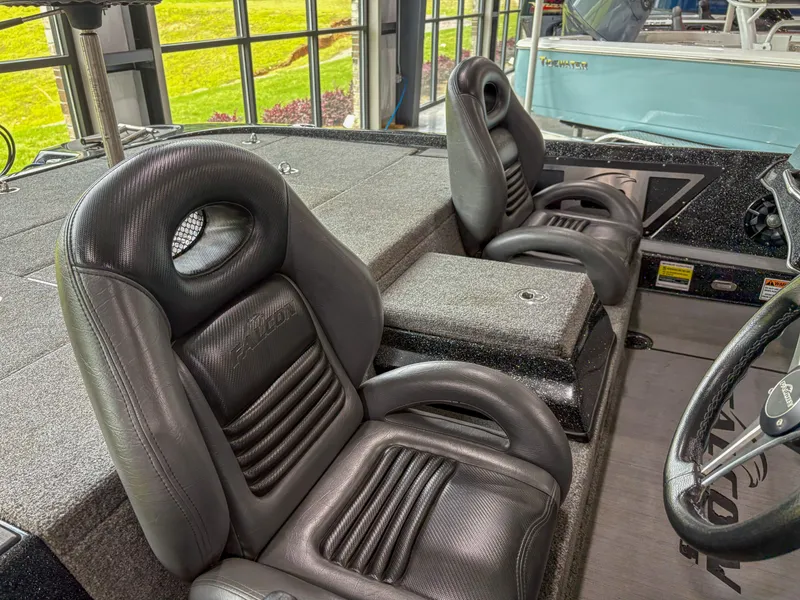 Slide: The Image of 2020 Falcon F21 boat interior with black leather seats and steering wheel. - 7