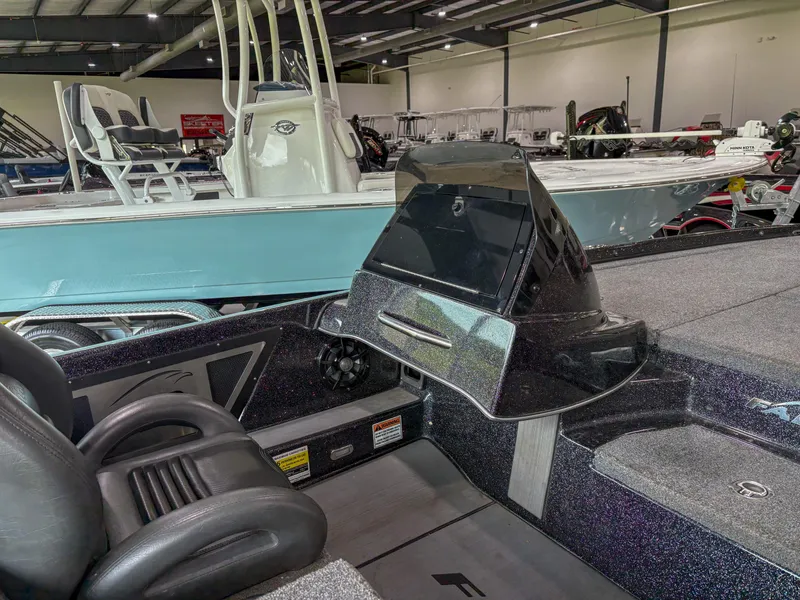 Slide: The Image of 2020 Falcon F21 boat interior with sleek dashboard and comfortable seating in a showroom. - 8