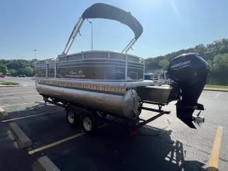 Slide: The Image of 2023 Sun Tracker Party Barge 20 DLX pontoon boat on trailer in parking lot. - 5