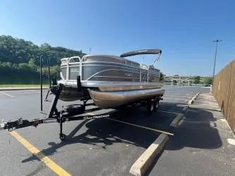 Slide: The Image of 2023 Sun Tracker Party Barge 20 DLX pontoon boat on trailer in parking lot. - 6
