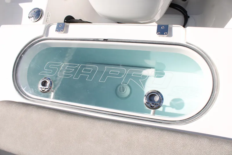 Slide: The Image of 2024 Sea Pro 240 boat livewell with clear lid and Sea Pro branding. - 12