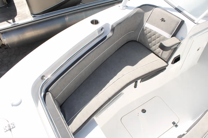 Slide: The Image of 2024 Sea Pro 240 boat interior with gray cushioned seating and storage compartment. - 26