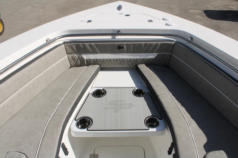 Slide: The Image of 2024 Sea Pro 240 boat interior with cushioned seating and cup holders. - 27