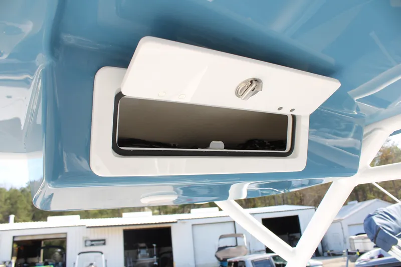 Slide: The Image of 2024 Sea Pro 240 boat storage compartment with blue and white finish. - 31