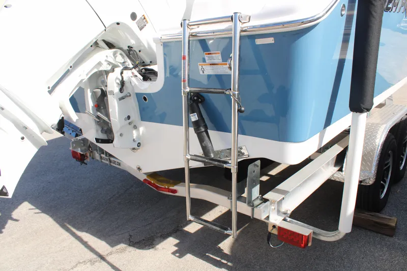 Slide: The Image of 2024 Sea Pro 240 boat stern with ladder and trailer, featuring a blue and white design. - 33