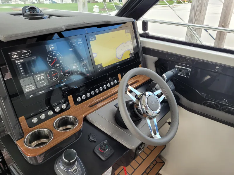 The Image of 2021 Tiara Sport 43LE luxury yacht docked in a marina, reflecting on calm water. - 0