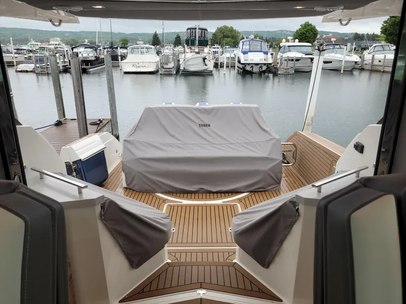 Slide: The Image of 2021 Tiara Sport 43LE yacht with covered grill, docked at marina. - 10