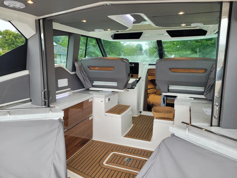 Slide: The Image of Interior of 2021 Tiara Sport 43 LE yacht with modern seating and wood flooring. - 20