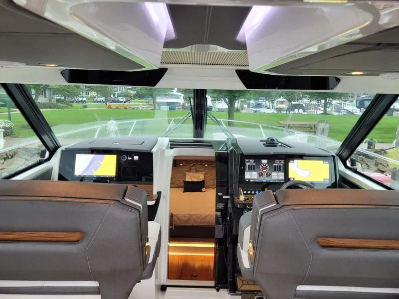 Slide: The Image of 2021 Tiara Sport 43LE helm with dual screens and luxurious seating. - 21