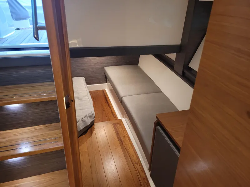 Slide: The Image of Interior of 2021 Tiara Sport 43LE yacht with wooden flooring and cushioned seating. - 30