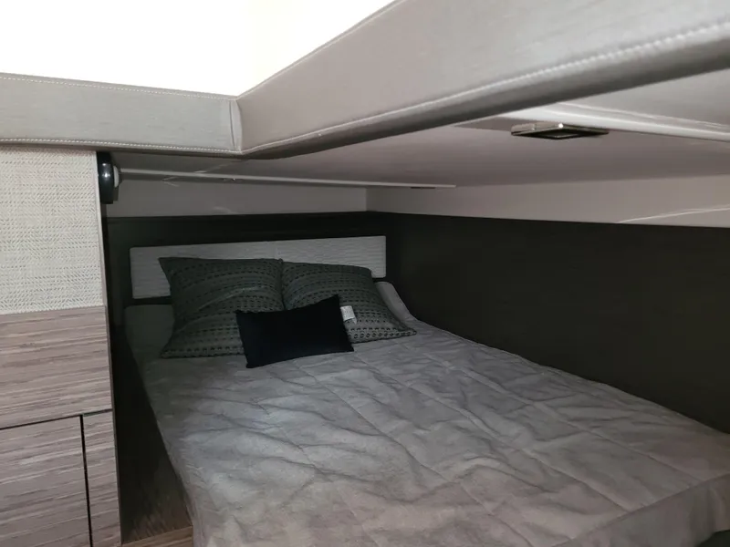 Slide: The Image of 2021 Tiara Sport 43LE cabin interior with cozy bed and modern design. - 32