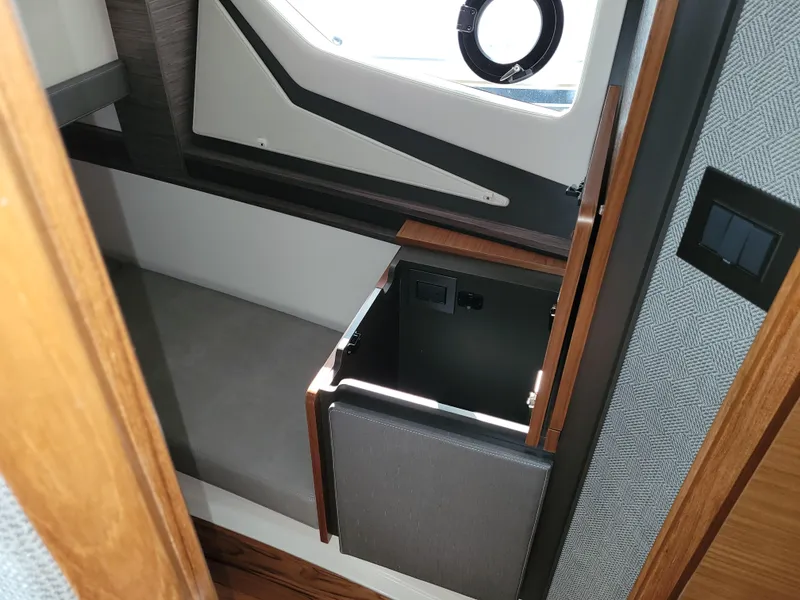 Slide: The Image of Interior of 2021 Tiara Sport 43LE boat, featuring a compact cabin space. - 33