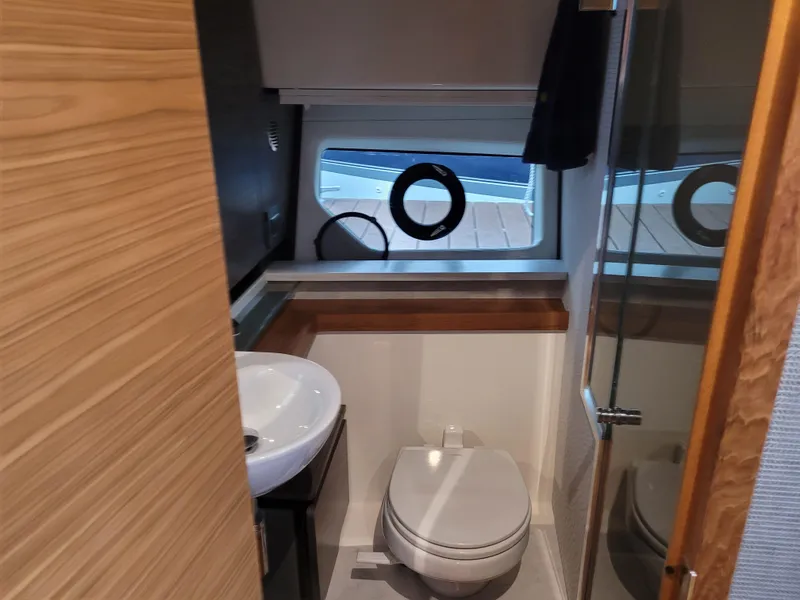 Slide: The Image of 2021 Tiara Sport 43LE yacht bathroom with modern fixtures and window view. - 35
