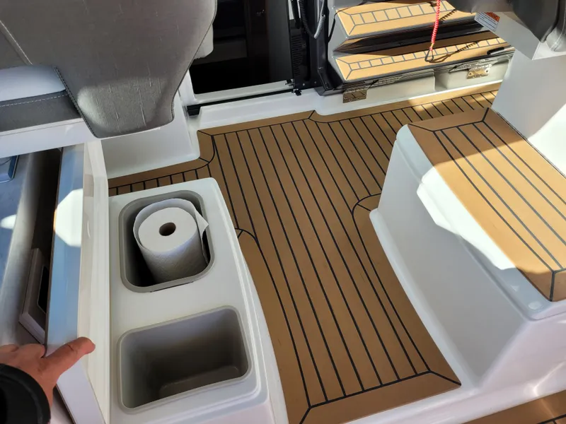 Slide: The Image of 2021 Tiara Sport 43 LE boat interior with teak flooring and storage compartments. - 39