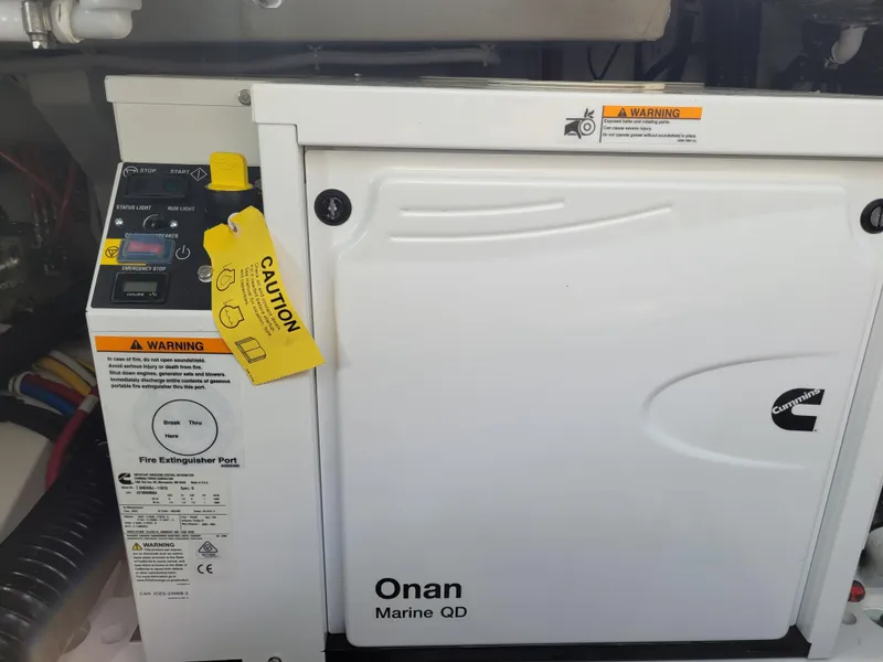 Slide: The Image of Onan Marine QD generator in a 2021 Tiara Sport 43LE boat engine room. - 42