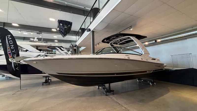 Slide: The Image of 2025 Monterey 298 Super Sport boat displayed in a showroom, side view. - 1