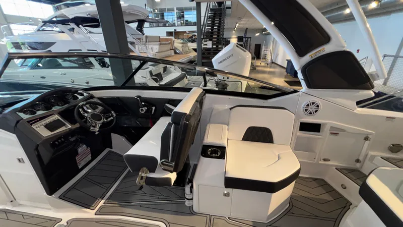 Slide: The Image of 2025 Monterey 298 Super Sport boat interior with modern seating and steering wheel. - 11