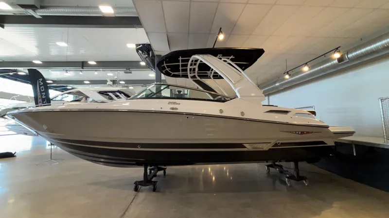 Slide: The Image of 2025 Monterey 298 Super Sport boat displayed indoors, showcasing sleek design and modern features. - 2