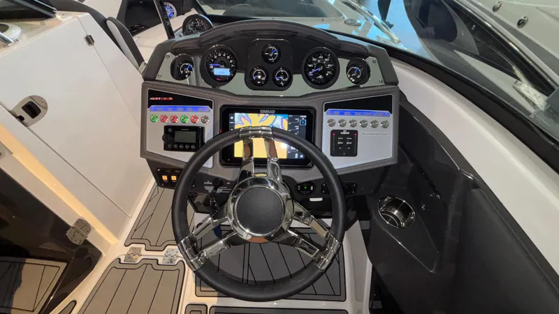 Slide: The Image of Cockpit of 2025 Monterey 298 Super Sport boat with modern controls and steering wheel. - 20