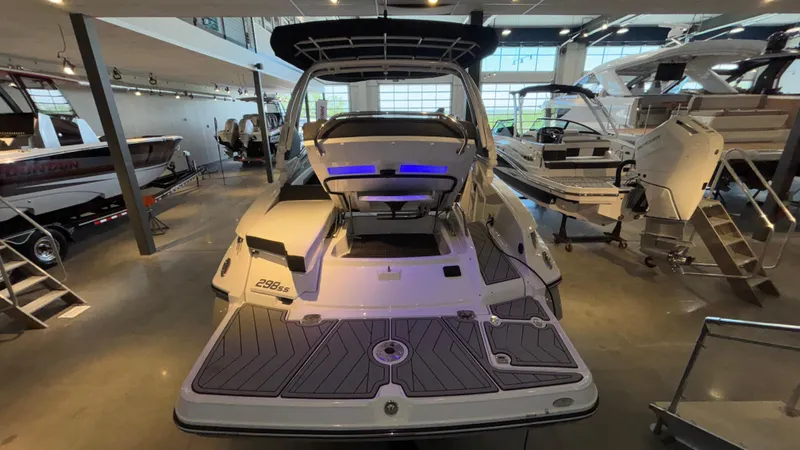 Slide: The Image of 2025 Monterey 298 Super Sport boat displayed in a showroom, rear view. - 26