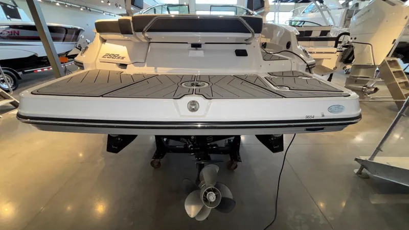 Slide: The Image of 2025 Monterey 298 Super Sport boat displayed in showroom, rear view with propeller visible. - 3