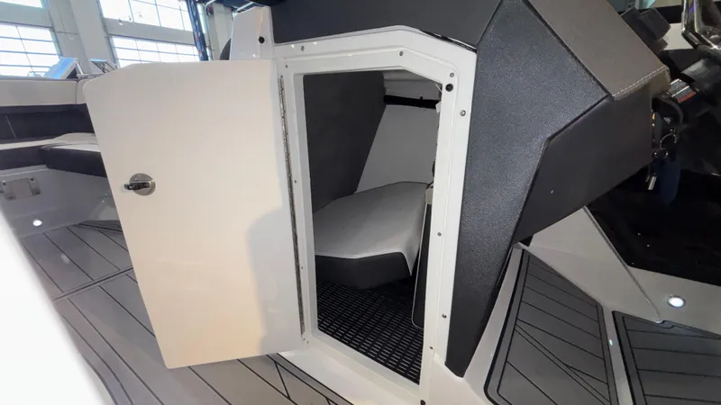 Slide: The Image of 2025 Monterey 298 Super Sport boat interior cabin with open door. - 31