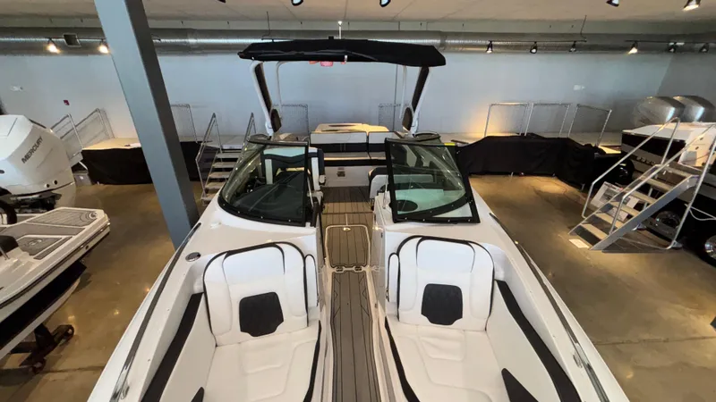 Slide: The Image of 2025 Monterey 298 Super Sport boat with sleek design and spacious seating in showroom. - 37