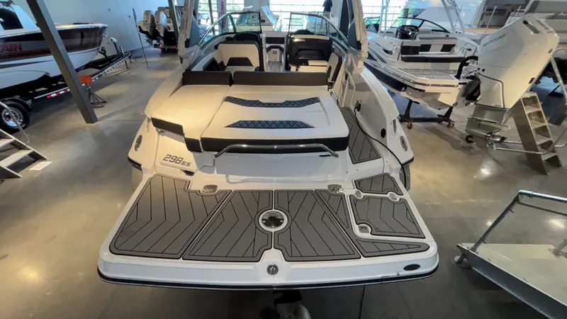 Slide: The Image of 2025 Monterey 298 Super Sport boat in showroom, rear view with sleek design. - 4