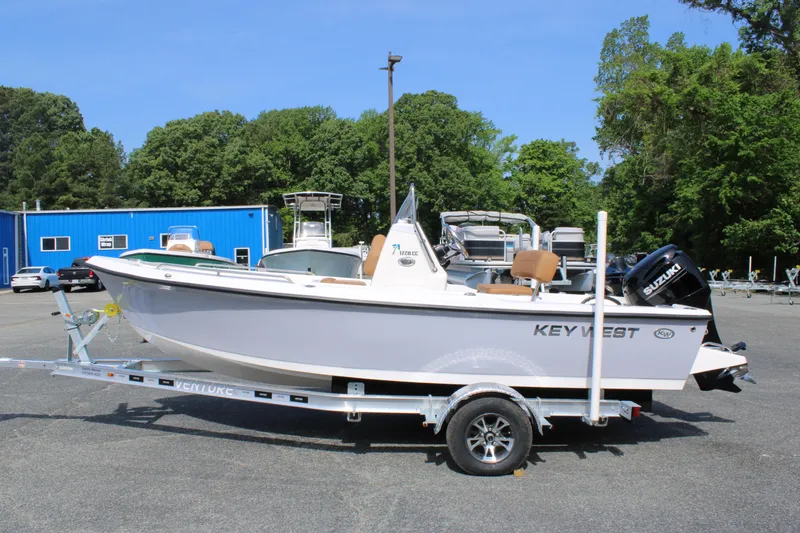 Slide: The Image of 2025 Key West 1720 Center Console boat on trailer in outdoor setting. - 1