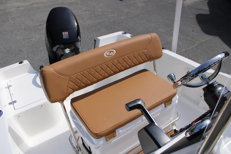 Slide: The Image of 2025 Key West 1720 Center Console boat interior with tan seating and steering wheel. - 10