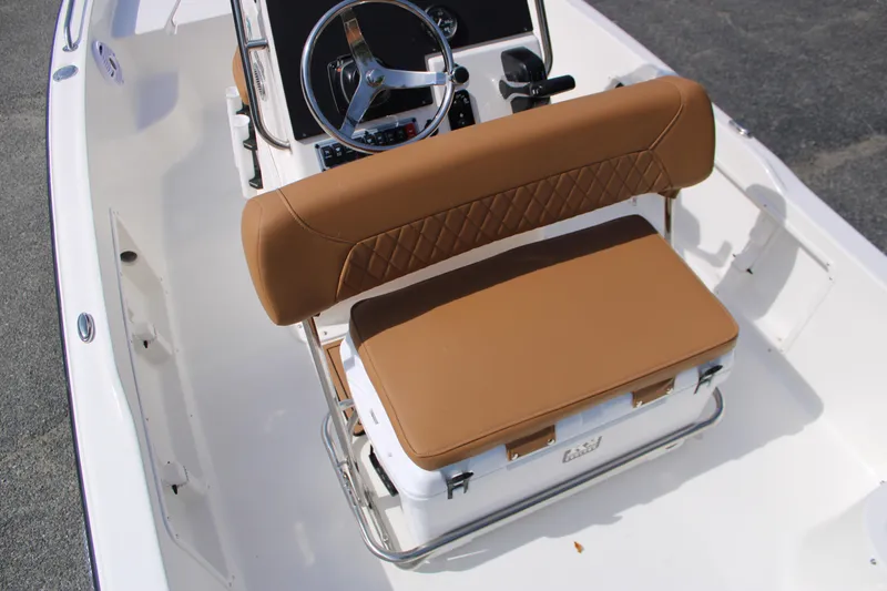 Slide: The Image of 2025 Key West 1720 Center Console boat with tan seating and steering wheel. - 11