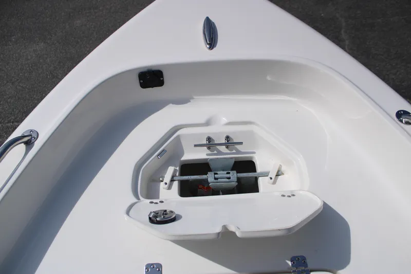 Slide: The Image of 2025 Key West 1720 Center Console boat anchor storage compartment, open lid, white interior. - 15